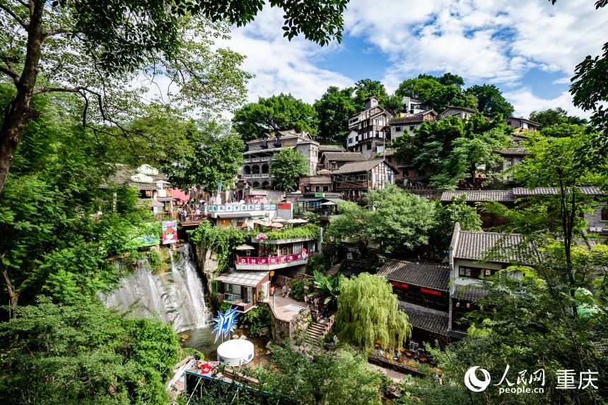 Hillside buildings, green lanes and a small waterfall at Xiahaoli Old Street
